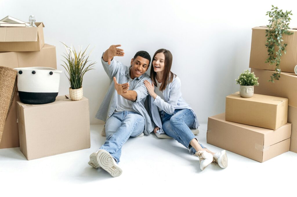 The moving, new housing. Happy young multiracial couple, caucasian woman and hispanic guy, are